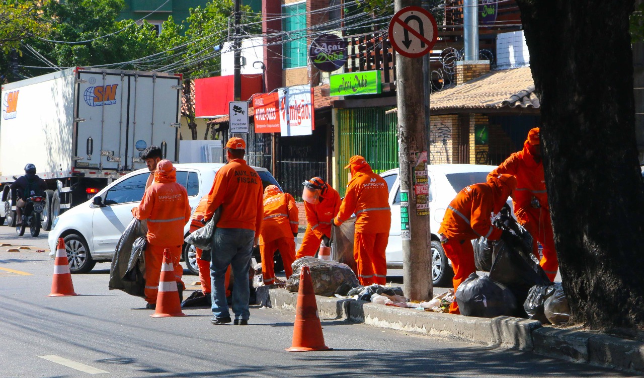 operários limpam canteiro central